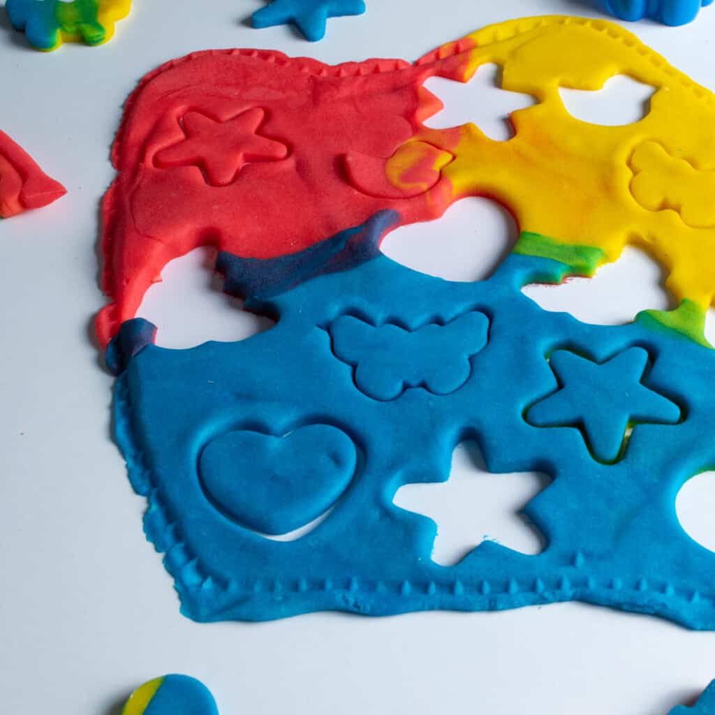 homemade rainbow colored play dough cut into shapes