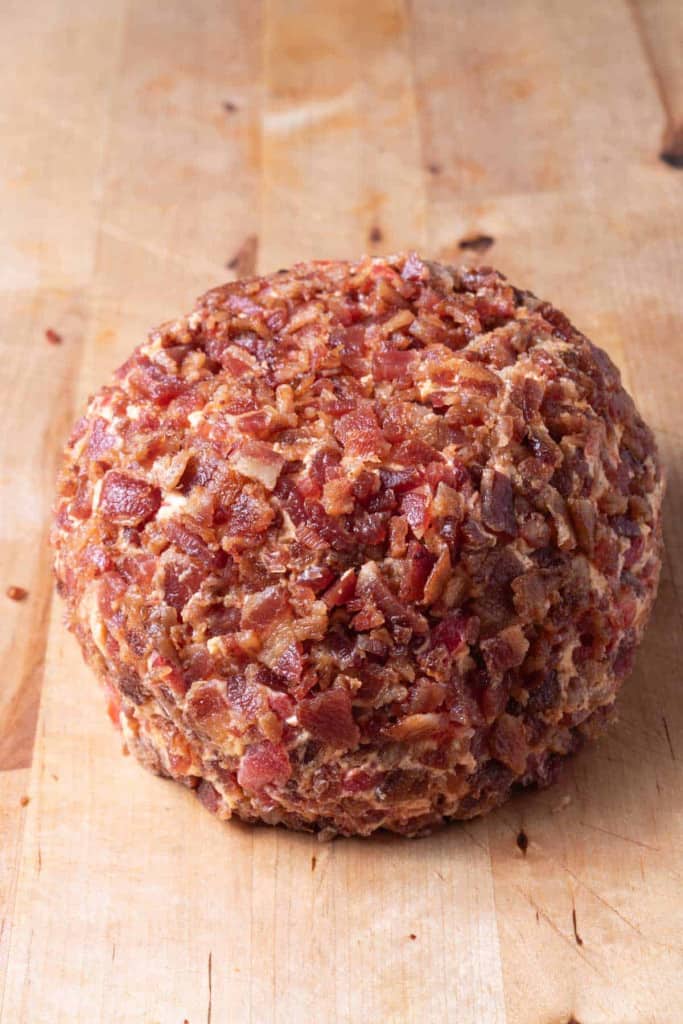 A cheeseball covered with bacon bits.