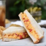 Homemade pimento cheese sandwich that is cut in half.