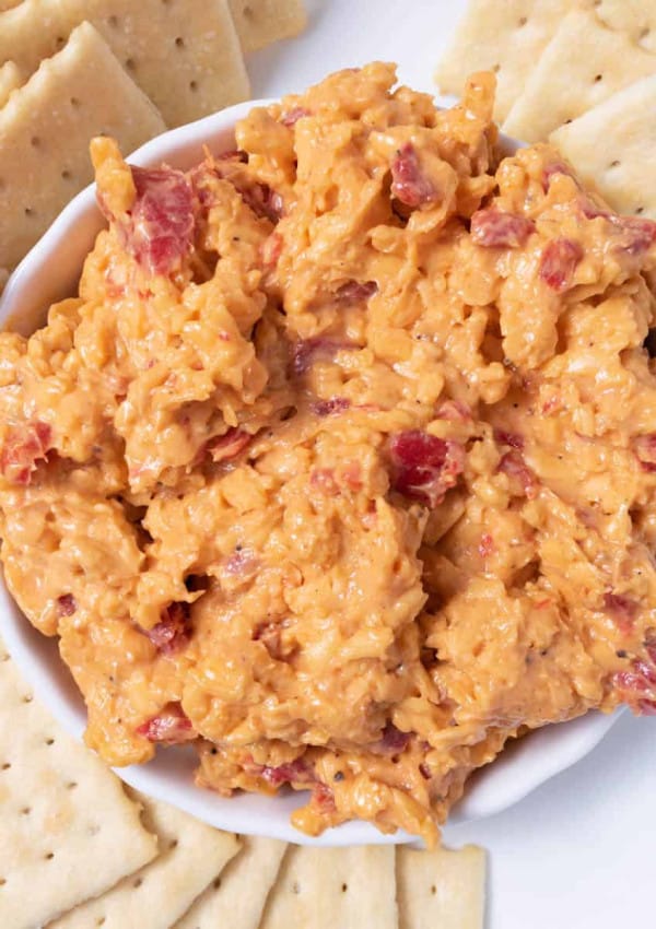 A dish of homemade pimento cheese spread with club crackers.