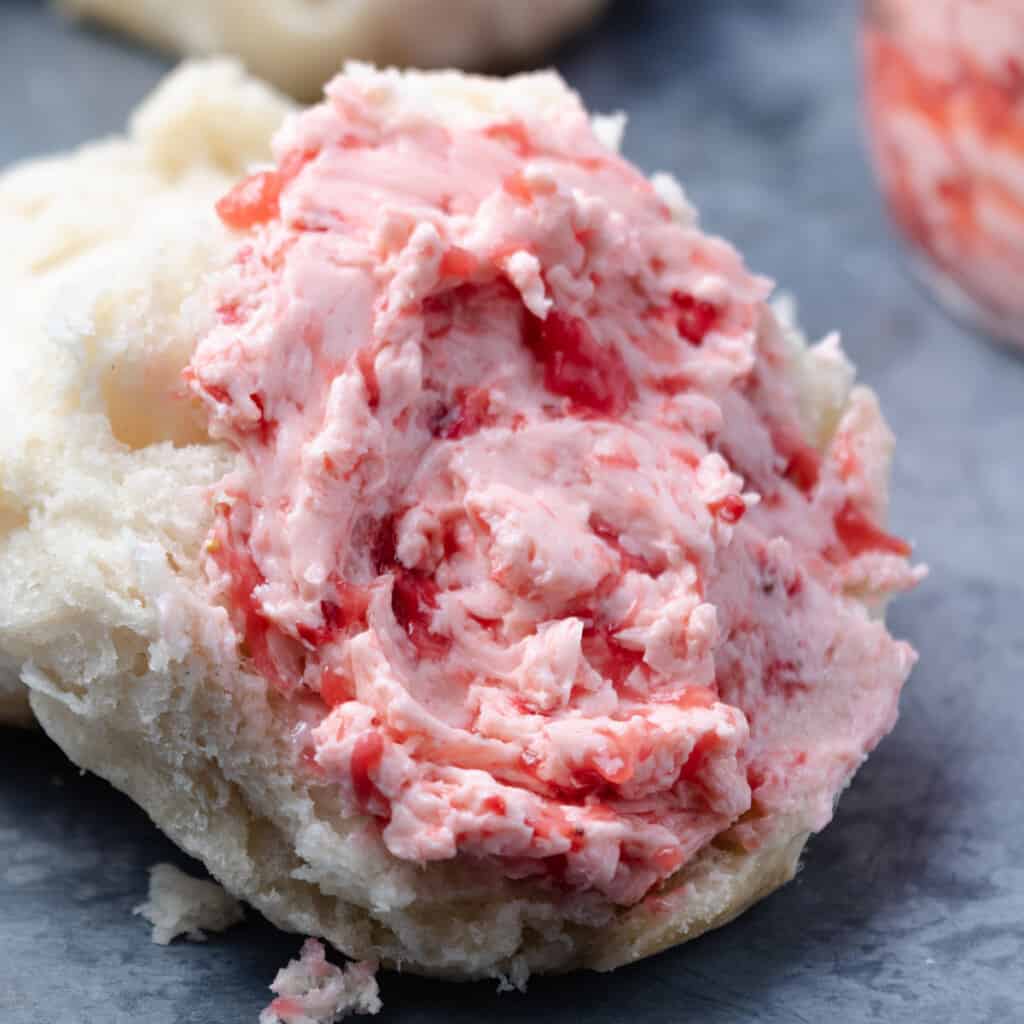 Strawberry butter smeared on a biscuit.