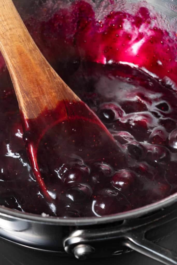Thickened blueberry pie filling in a pot.