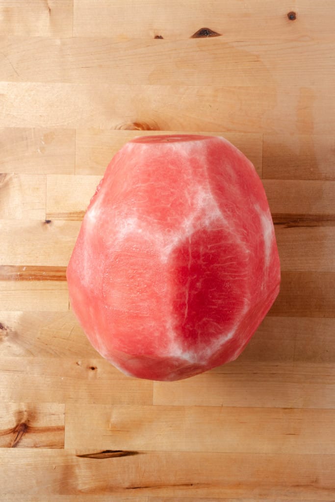 A watermelon with the rind cut off.