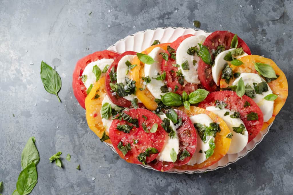 Caprese made from red, yellow, and Cherokee purple heirloom tomatoes.