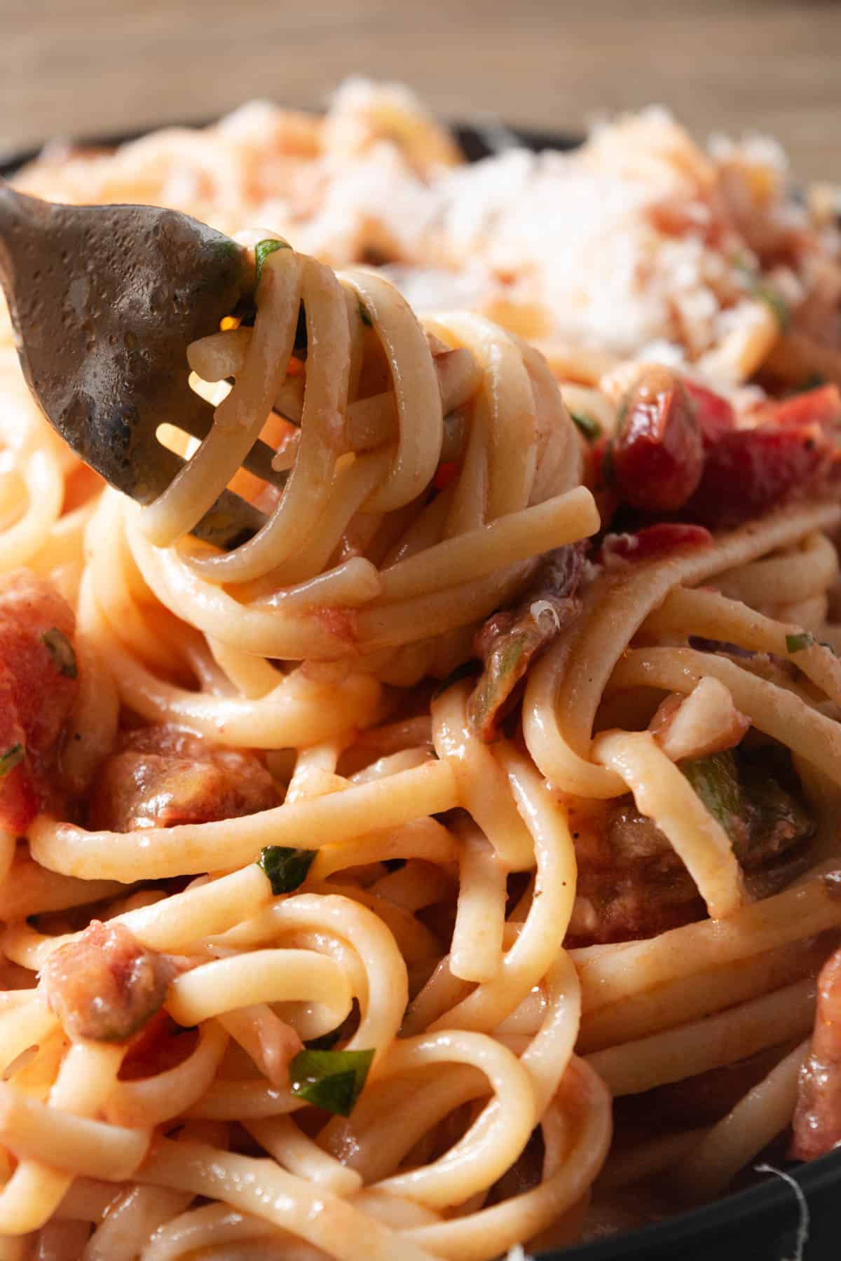 Twirling fresh summer linguine around a fork.