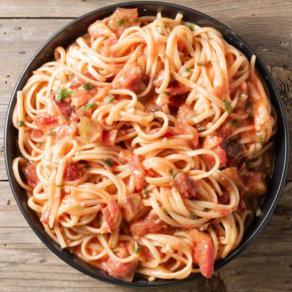 A bowl of tomato and brie pasta.