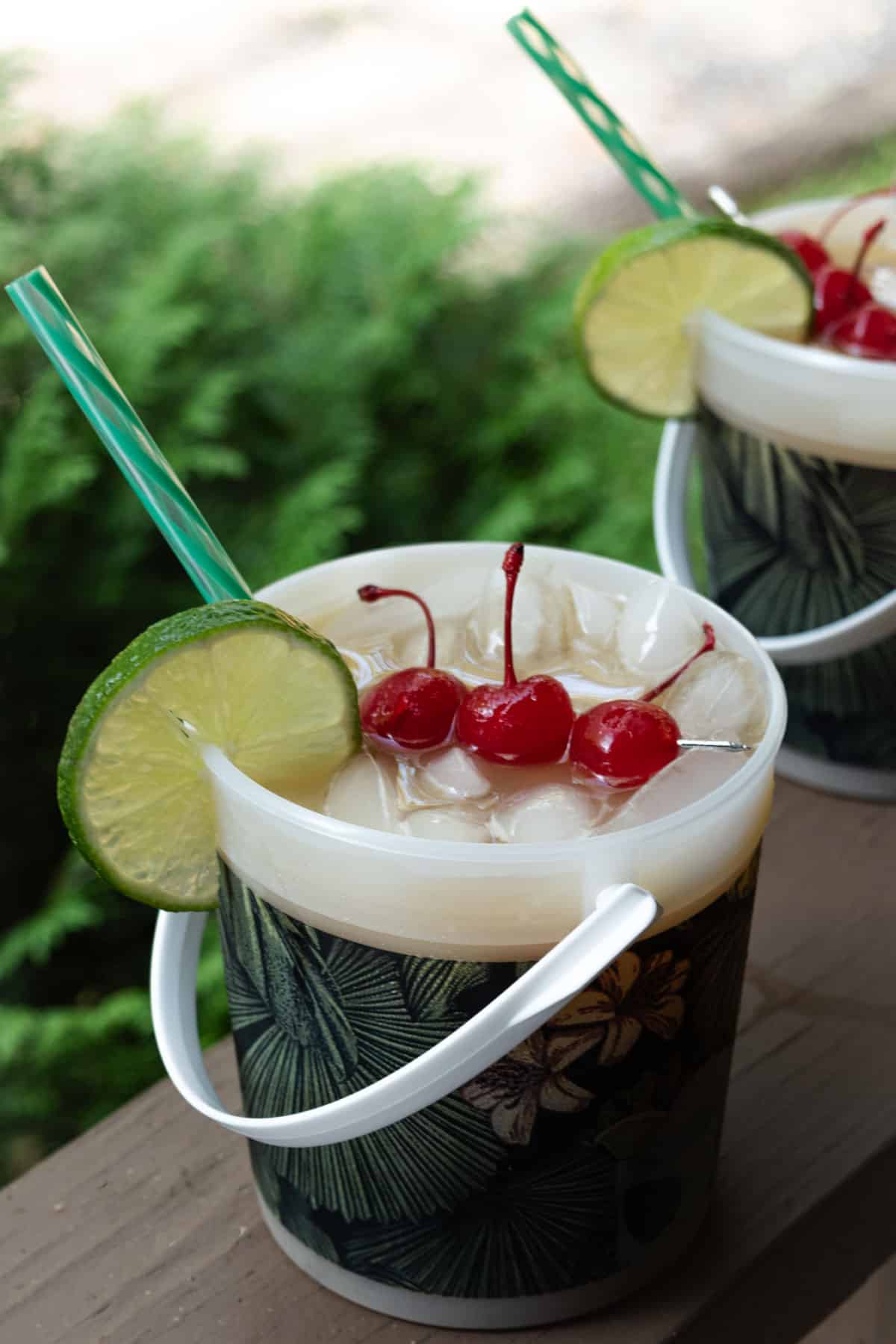 A bucket of Bacardi rum punch with cherries, lime, orange juice, pineapple, and pomegranate.