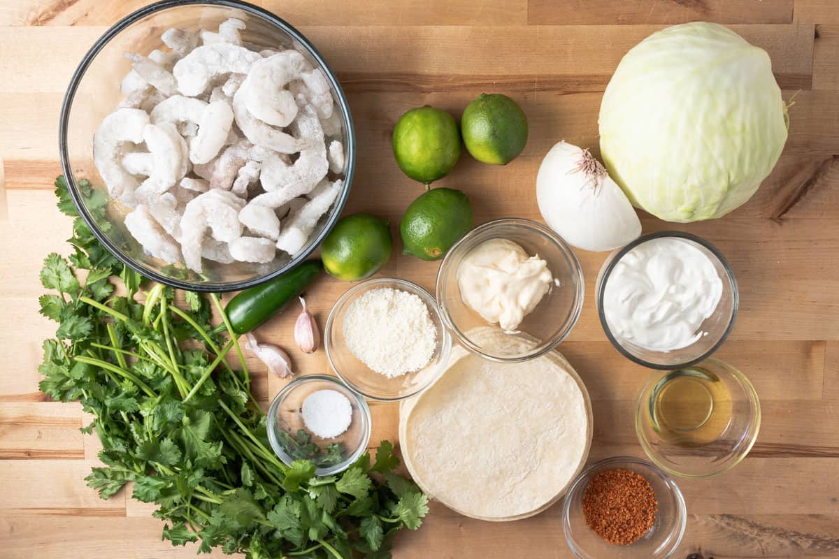 Ingredients for making chili lime shrimp tacos with a cilantro lime crema.