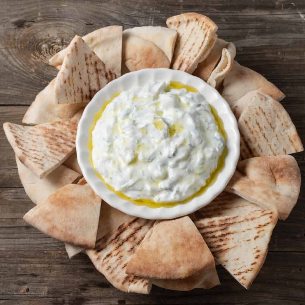 Tzatziki sauce with sour cream served with pita wedges.