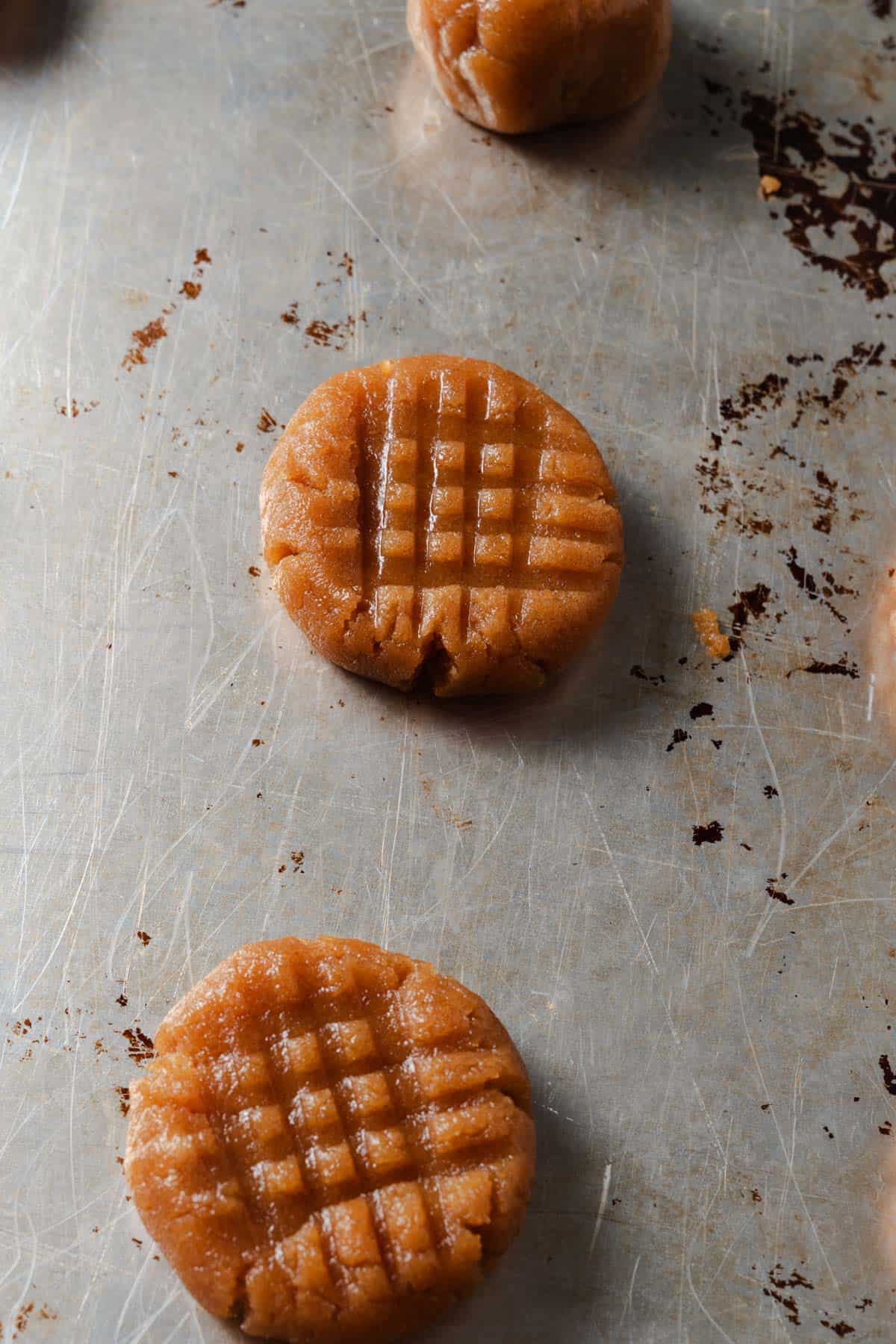 Peanut butter cookie dough with criss cross marks.