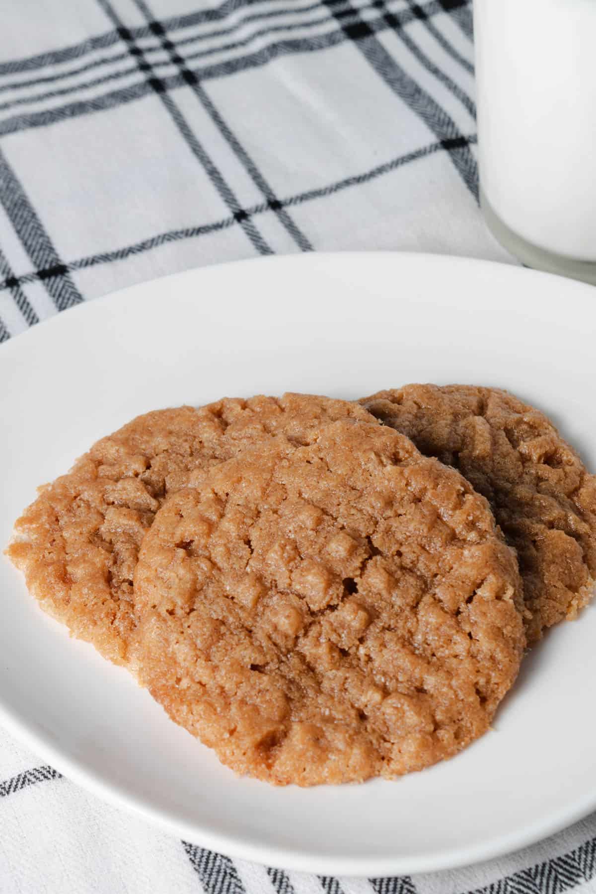 Freshly baked peanut butter cookies on a white plate.