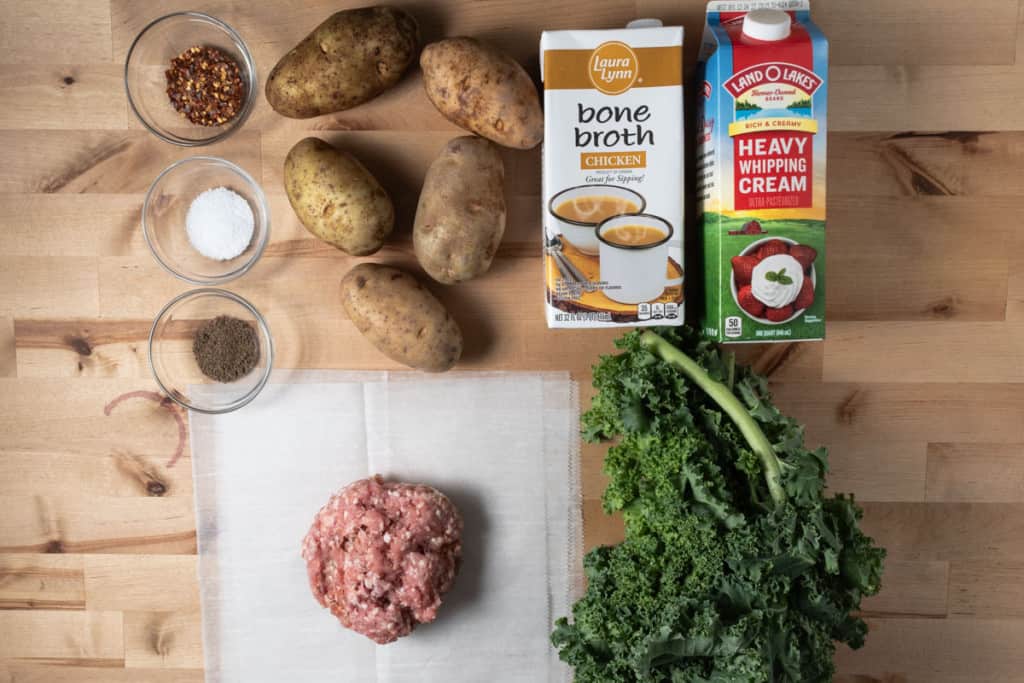 Italian sausage, kale, chicken stock, heavy cream, potatoes, salt, pepper, and red pepper flakes for making soup.