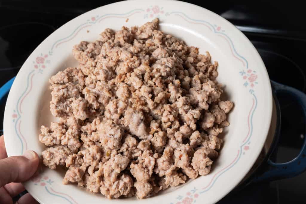 A bowl of browned Italian sausage crumbles.