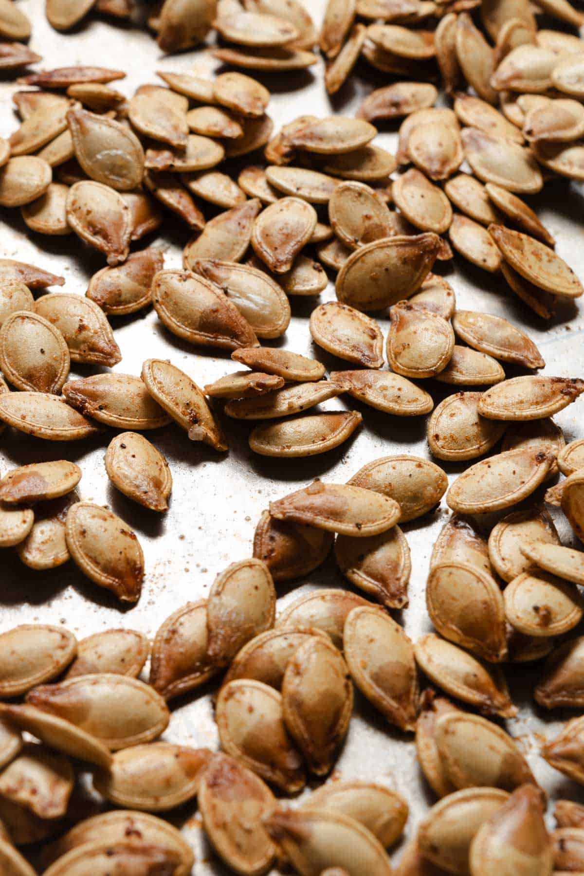 Pumpkin seeds on a sheet pan.