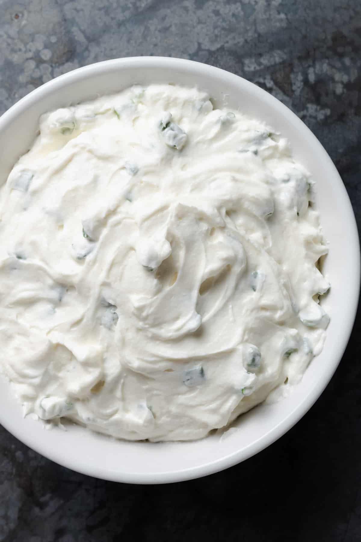 A bowl of homemade scallion cream cheese spread.