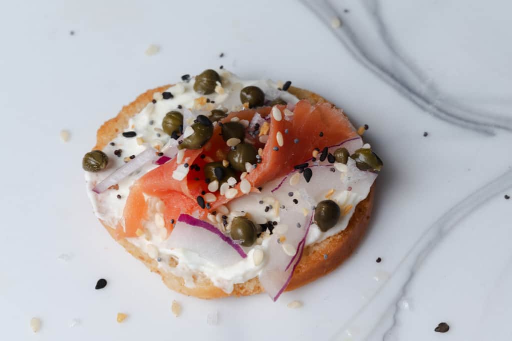 A smoked salmon canape with everything bagel seasoning.