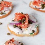 A smoked salmon crostini on a platter.