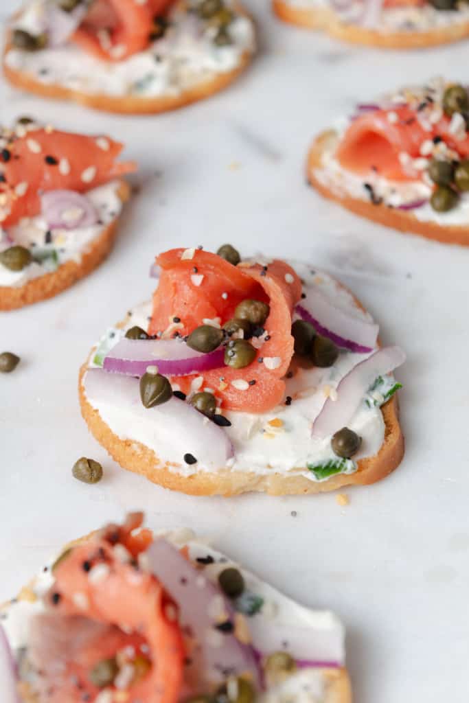 A smoked salmon crostini on a platter.