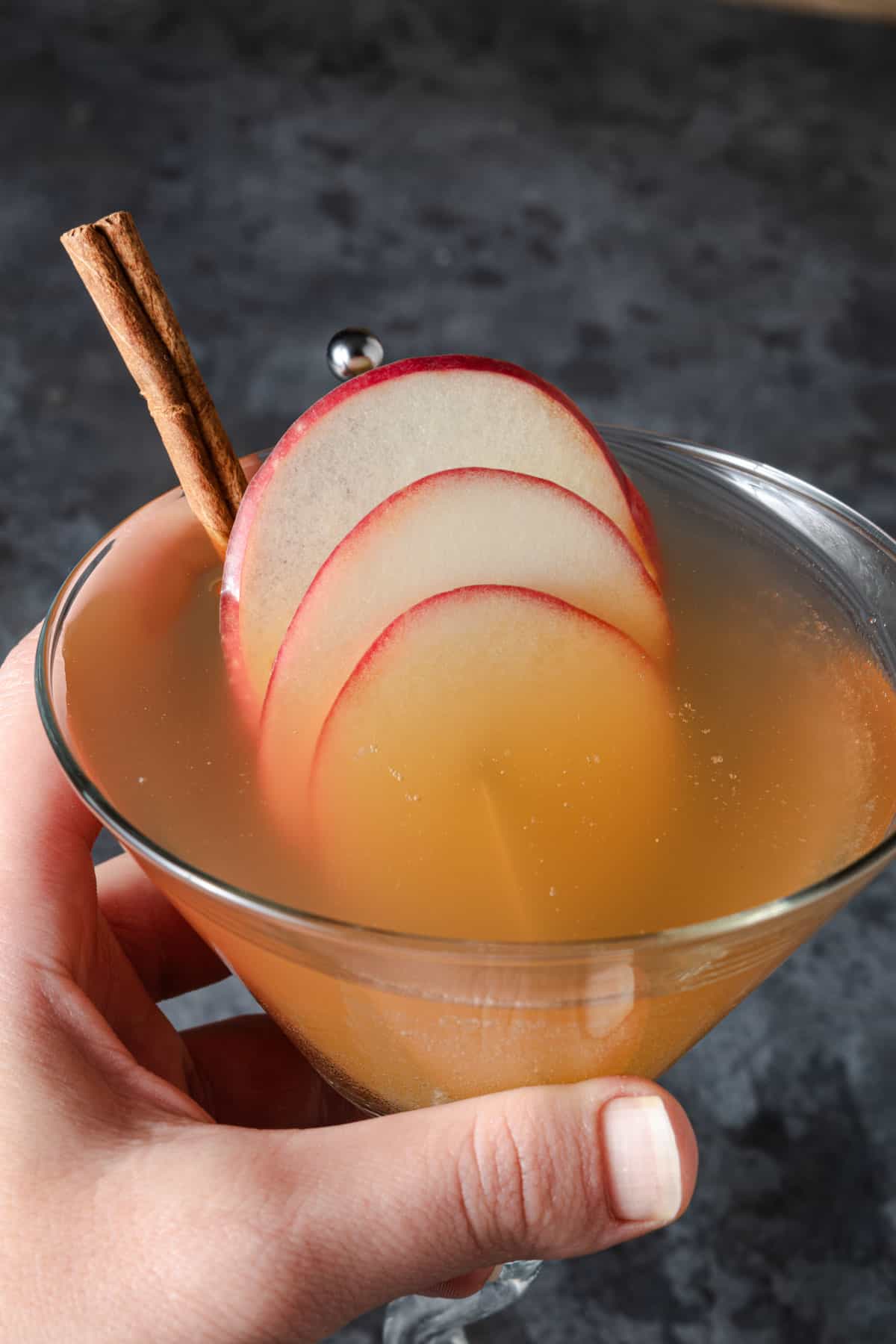Holding a freshly made apple cider martini.