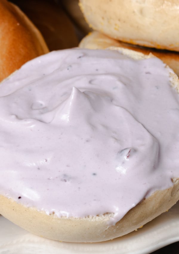 Homemade whipped blueberry cream cheese spread on a bagel.