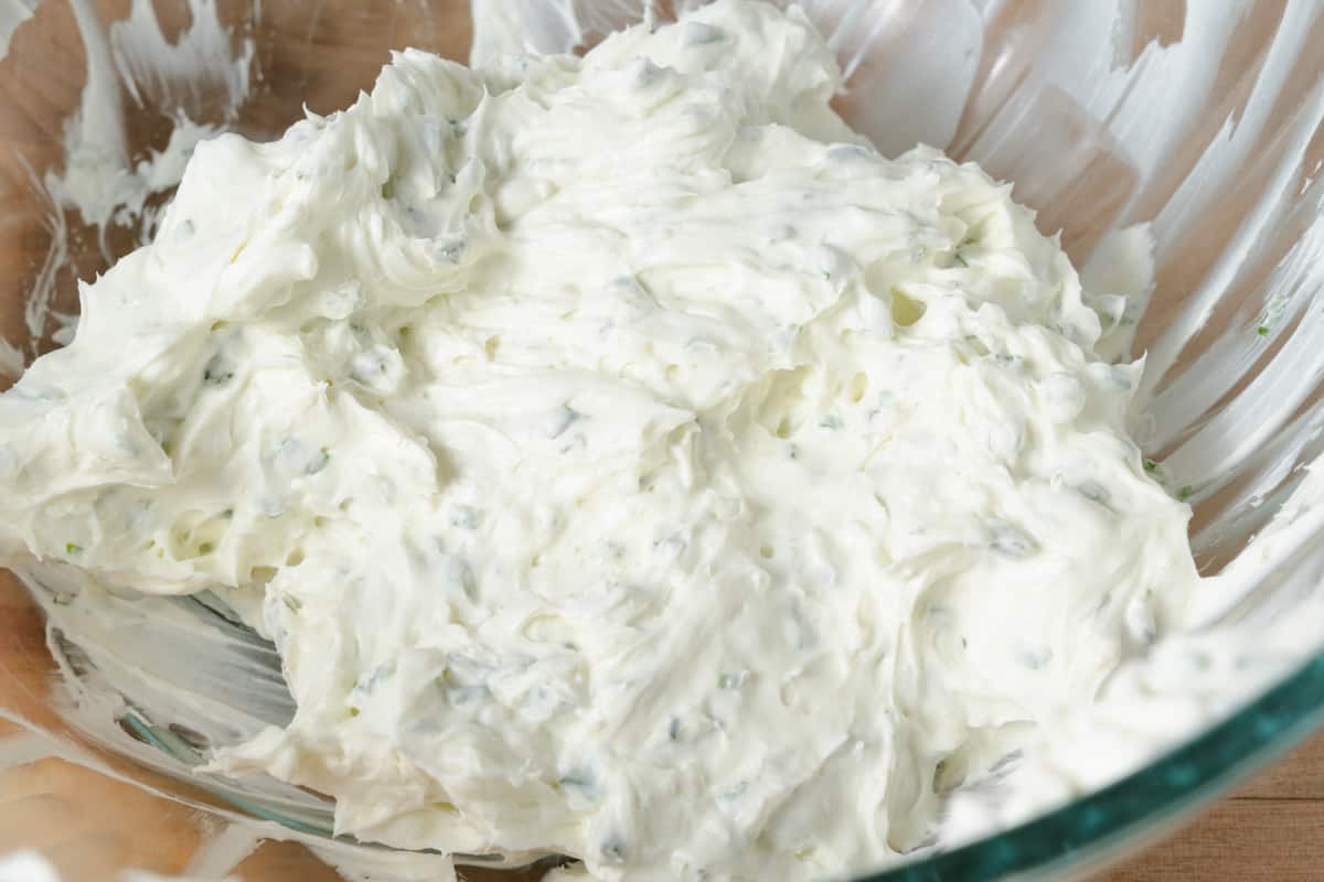 A bowl of homemade double whipped chive and onion cream cheese.
