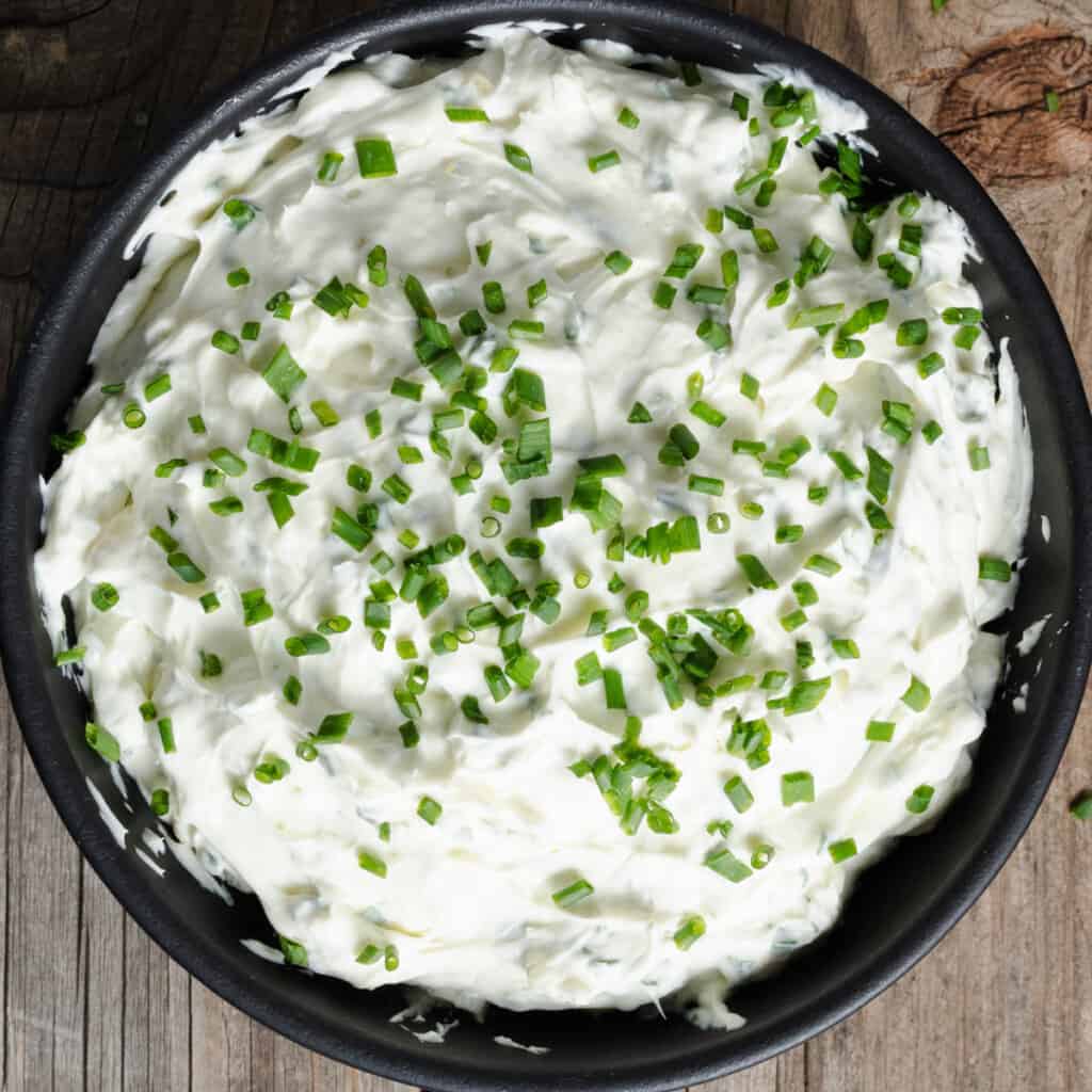 A bowl of double whipped chive and onion cream cheese spread.