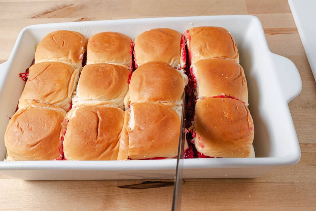 Cutting pull apart sliders before baking.