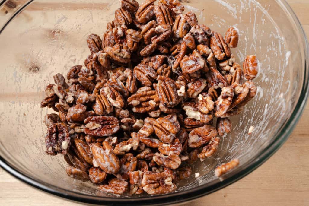 Pecan halves tossed in frothy egg whites.