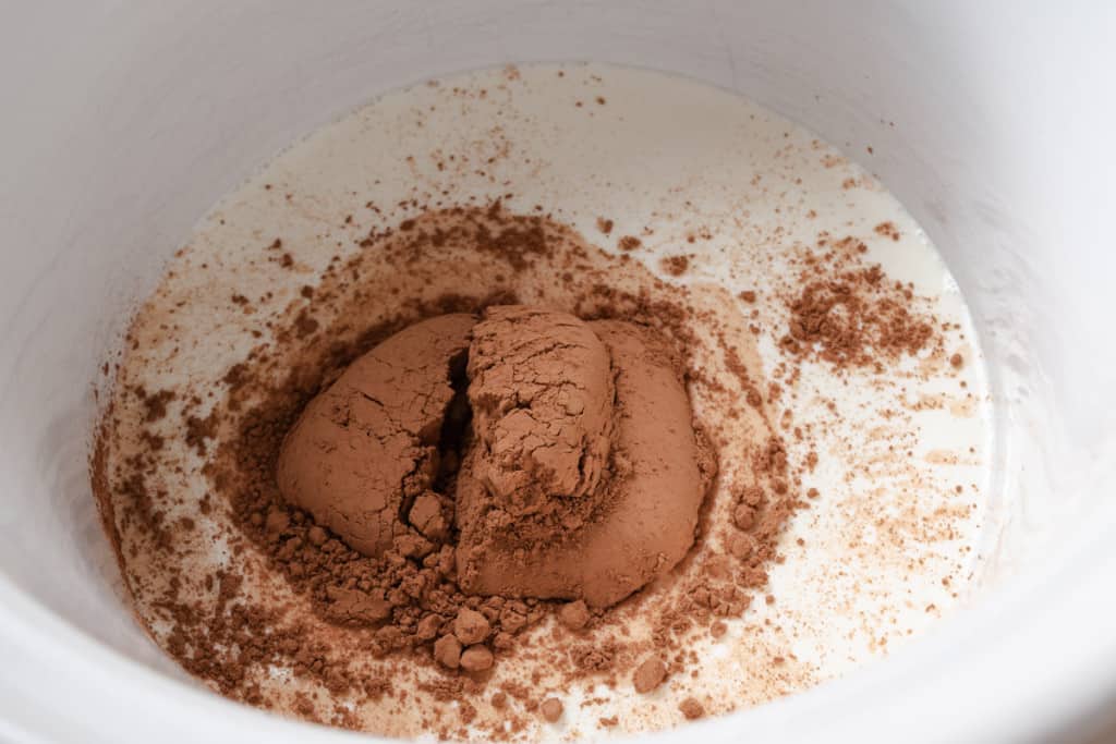 Cream and cocoa powder in a crock pot.