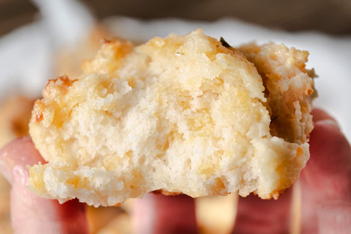 The inside of a homemade tender cheddar biscuit.