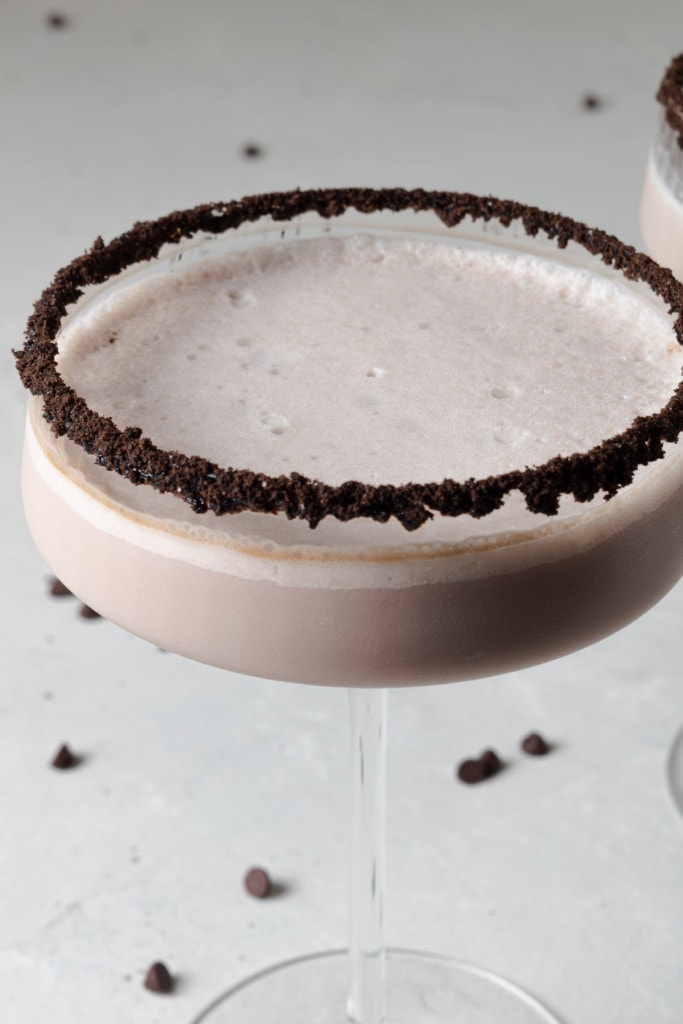 A chocolate martini in a cookie rimmed coupe glass.