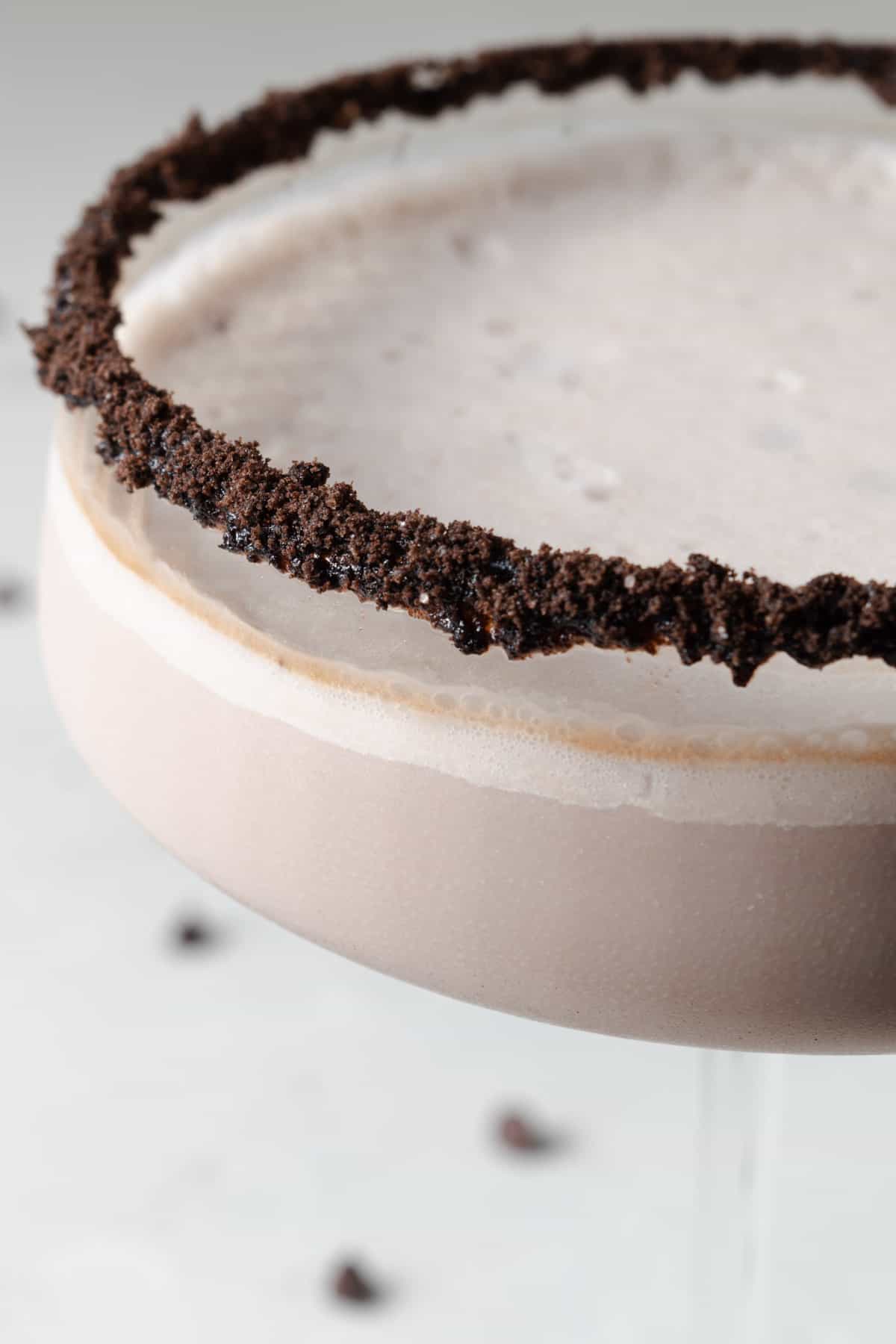 A chocolate liqueur cocktail in a fancy chocolate rimmed glass.