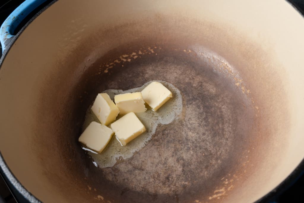 Melting butter in a enameled Dutch oven.