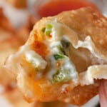 The middle of a fried jalapeno and cream cheese wonton.