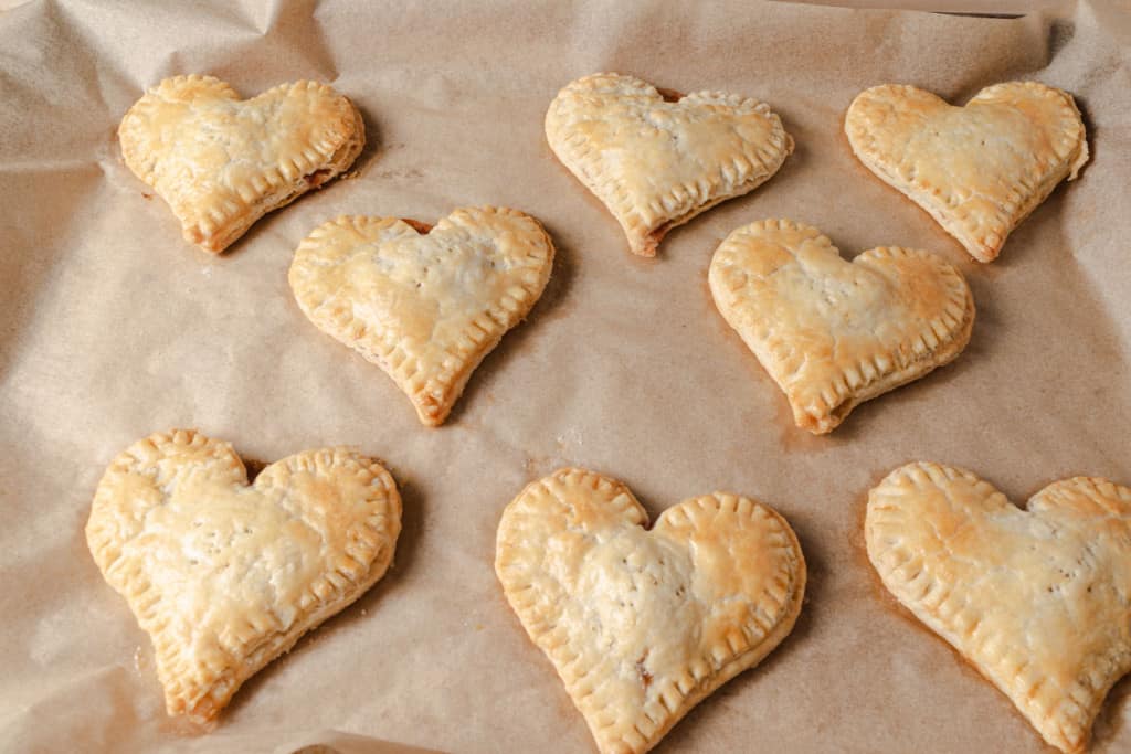 Freshly baked heart-shaped strawberry hand pies.