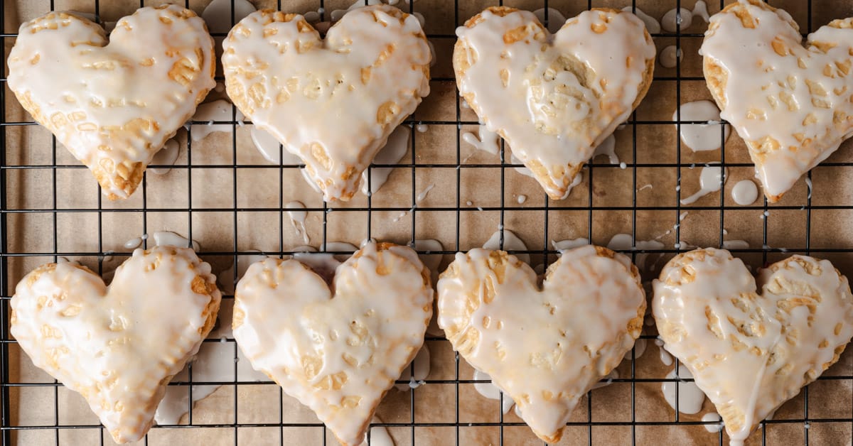 Heart-shaped mini pies on a cooling rack.