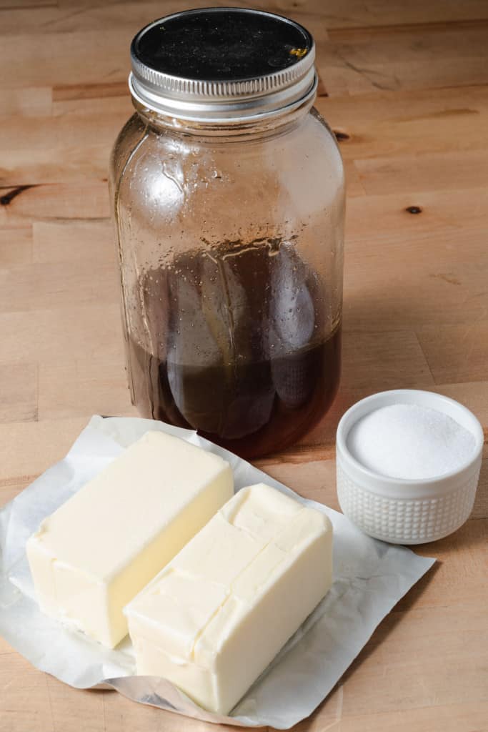 A jar of honey, sticks of butter, and salt for making a compound butter.