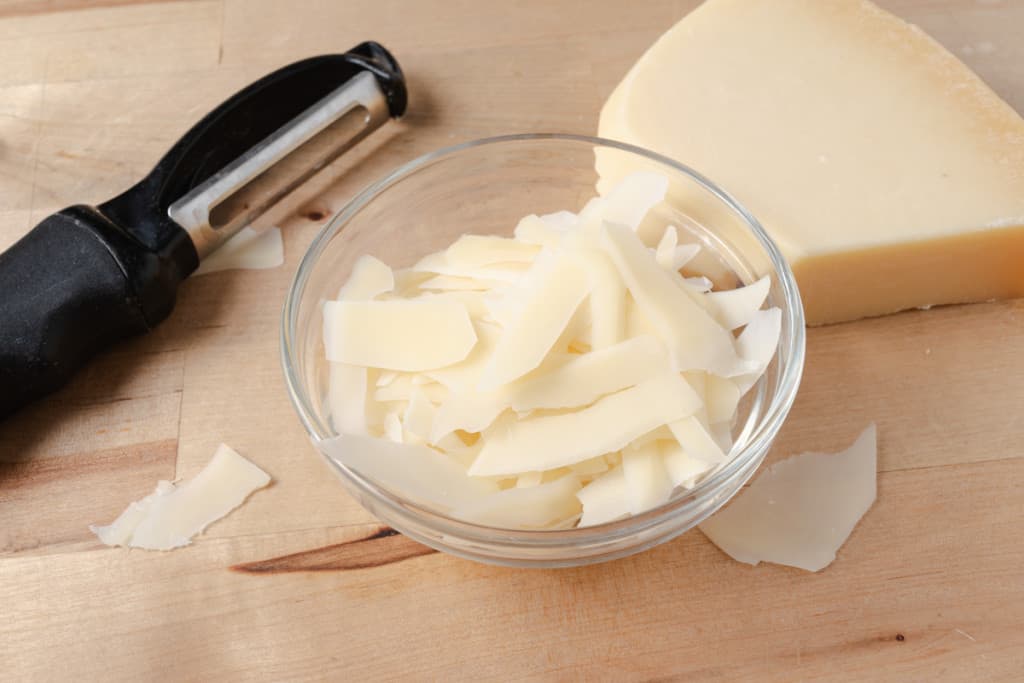 Parmesan cheese shaved with a vegetable peeler.