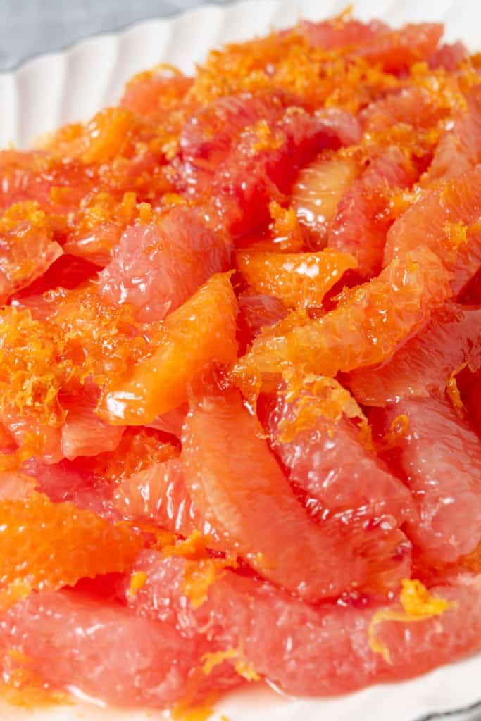 A citrus salad made from supremes of grapefruit, blood oranges, cara cara oranges, mandarin oranges, zest, and honey.