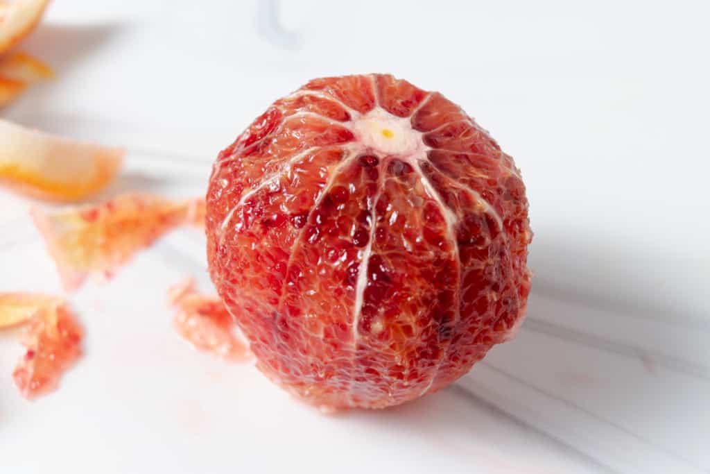 A blood orange with all the peelings and pith cut off.