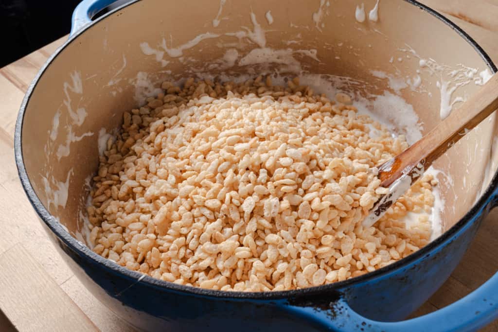 A rice krispies in a pot of melted marshmallows and butter.