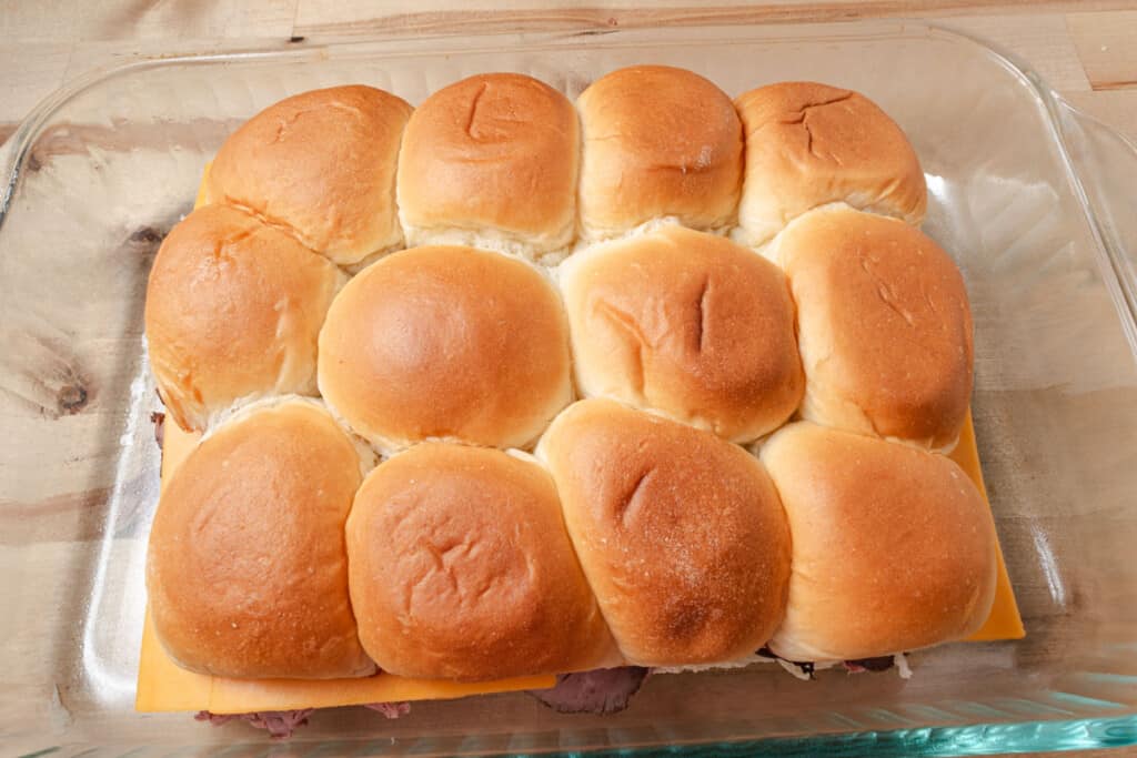 A pan of mini beef and cheese sandwiches.