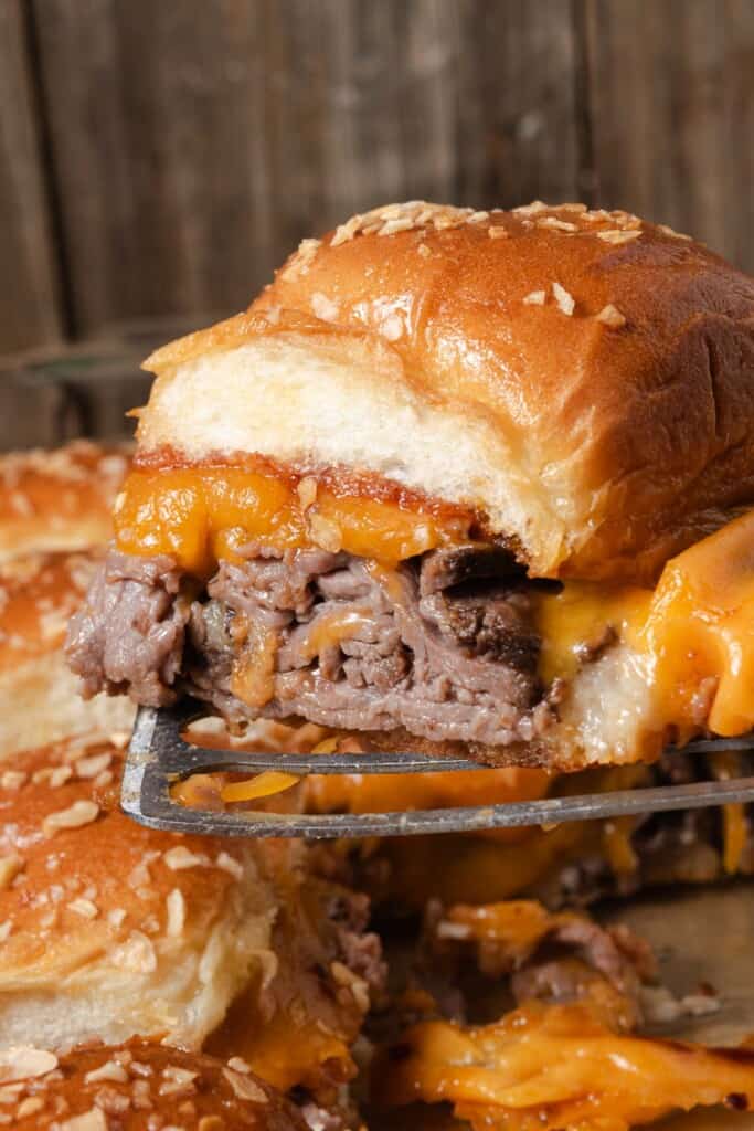 An oven-baked roast beef and cheddar slider straight from the pan.