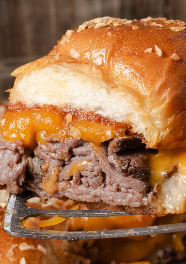 A hot and melted roast beef slider on a Kings Hawaiian roll.