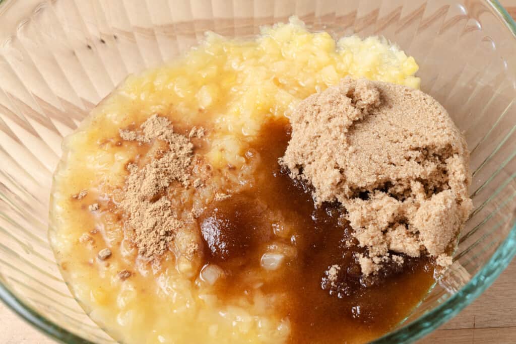 Crushed pineapple, brown sugar, and ground ginger in a mixing bowl.