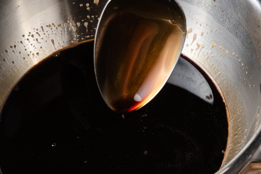 Homemade balsamic glaze that is thick enough to coat a spoon.