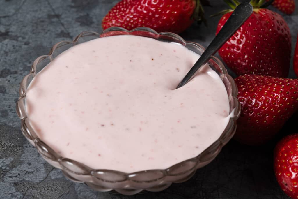 A bowl of 3 ingredient strawberry cream cheese dip with fresh strawberries.