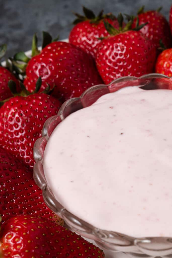 A bowl of 3 ingredient strawberry cream cheese dip with fresh strawberries.