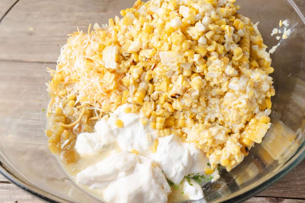 Ingredients for Mexican street corn dip in a large mixing bowl.