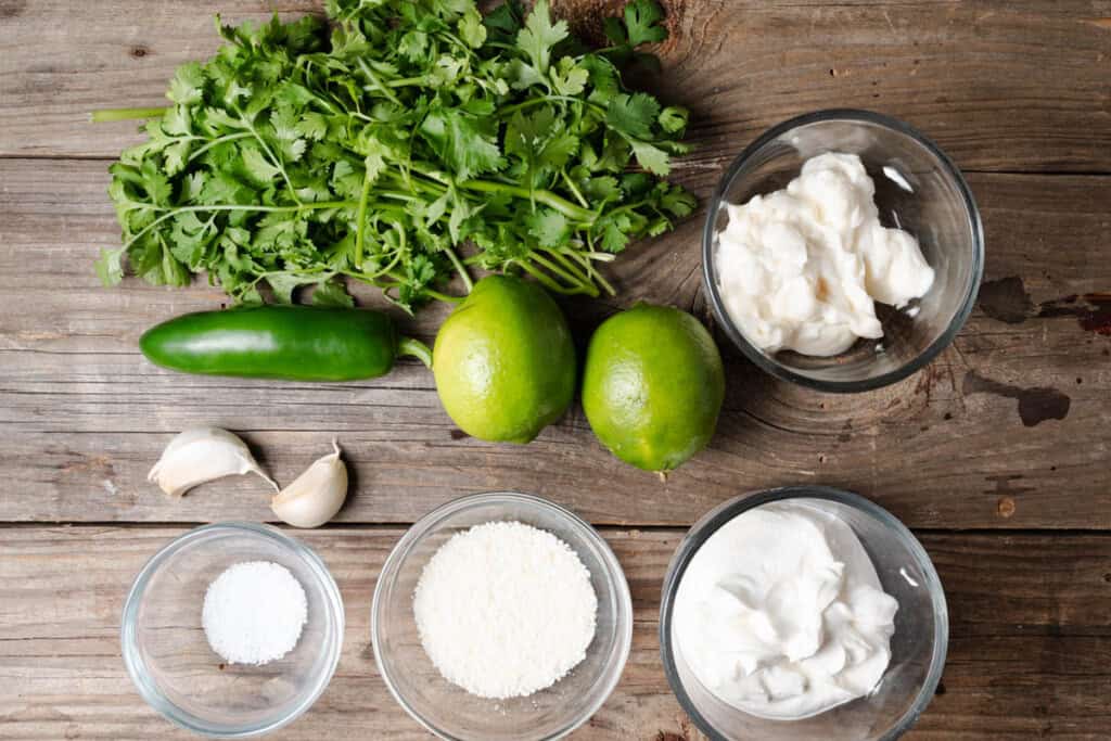 Cilantro, jalapeno, limes, garlic, mayonnaise, cotija cheese, and salt.